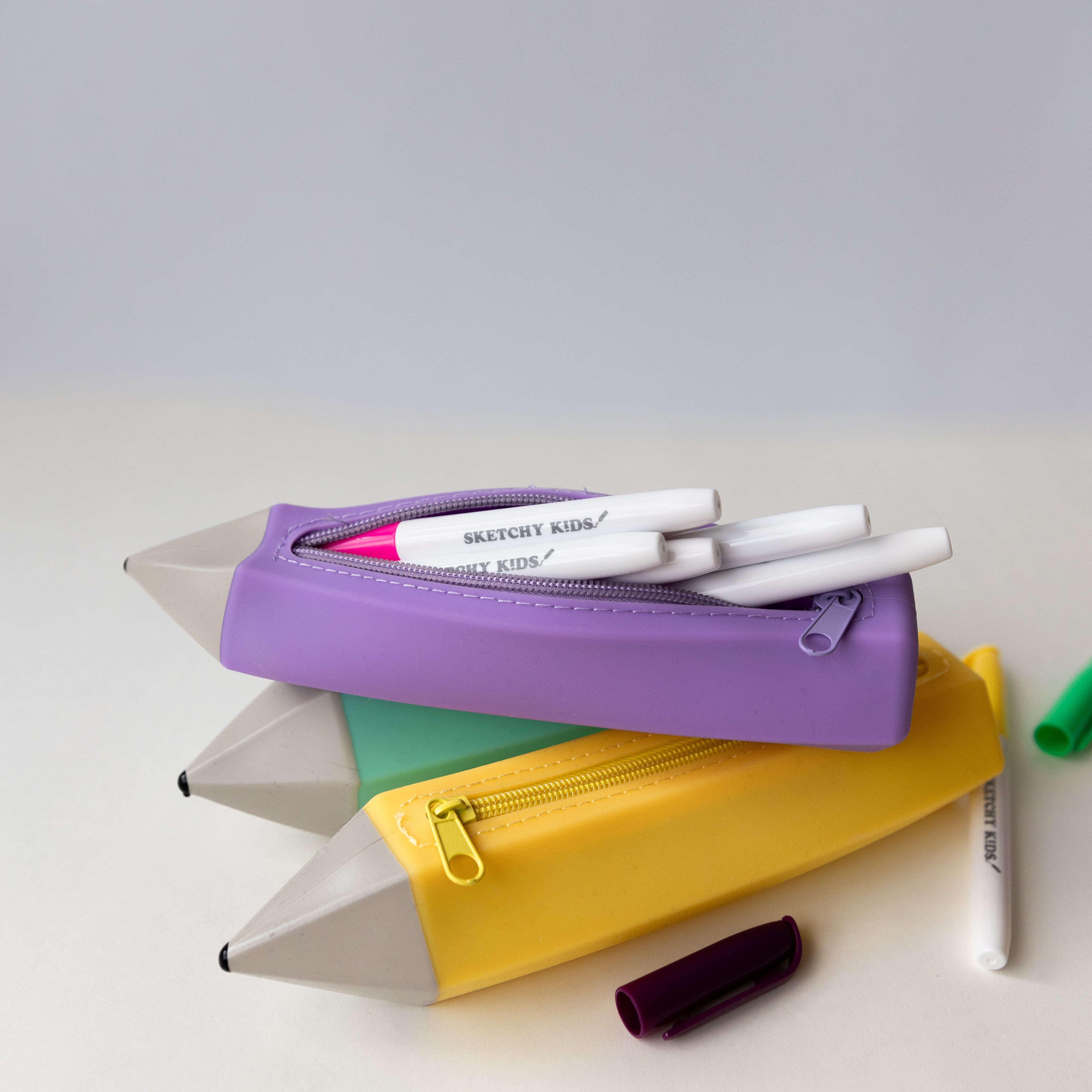 turqoise, purple and yellow silicone pencil shaped pencil case