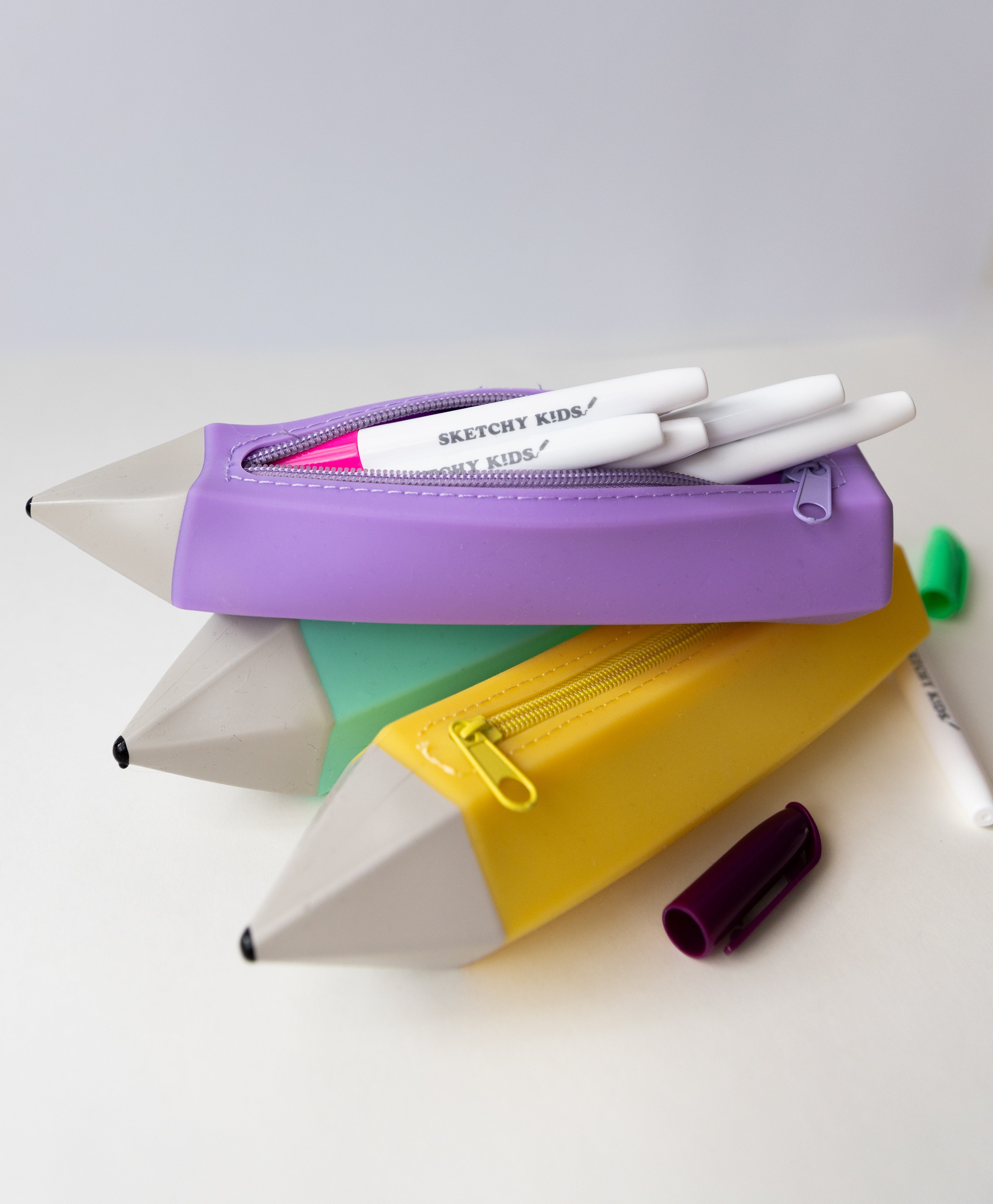turqoise, purple and yellow silicone pencil shaped pencil case