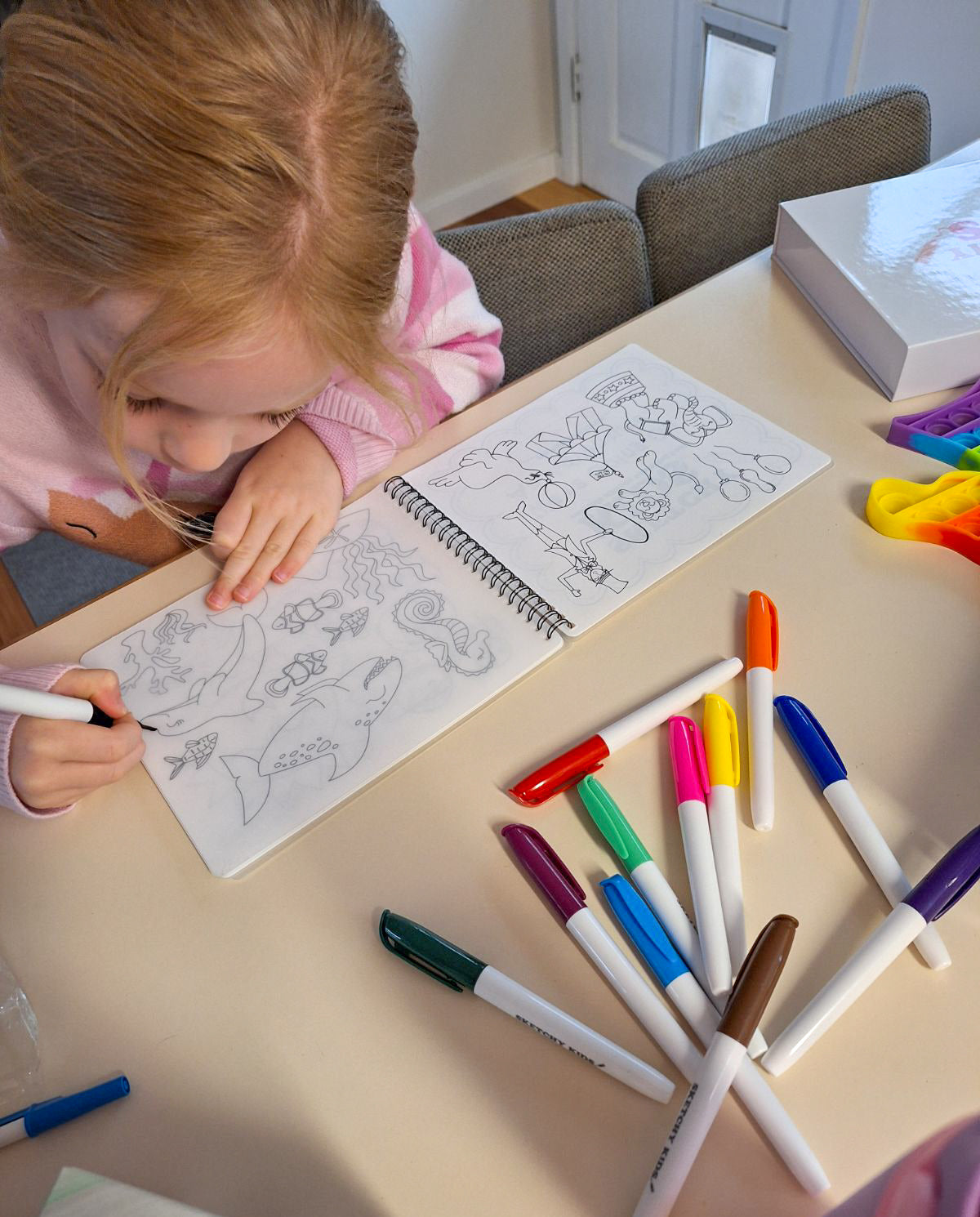 Child using reusable colouring book by Sketchy Kids